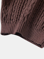 Kahvinruskean jacquard-neulepikeepaidan ribbineulotun hihansuun yksityiskohta