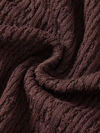 Kahvinruskean geometrisen jacquard-neuloksen lähikuva