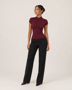 Ava wine-burgundy short-sleeve keyhole zip-front top, three-quarter full-body catalog view