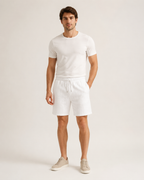 Male model wearing white cable-jacquard drawstring shorts in a neutral studio