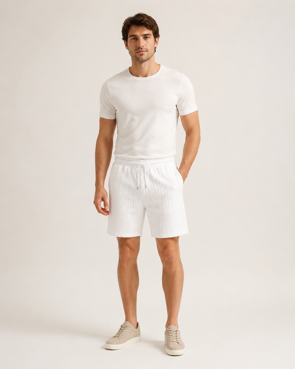 Male model wearing white cable-jacquard drawstring shorts in a neutral studio