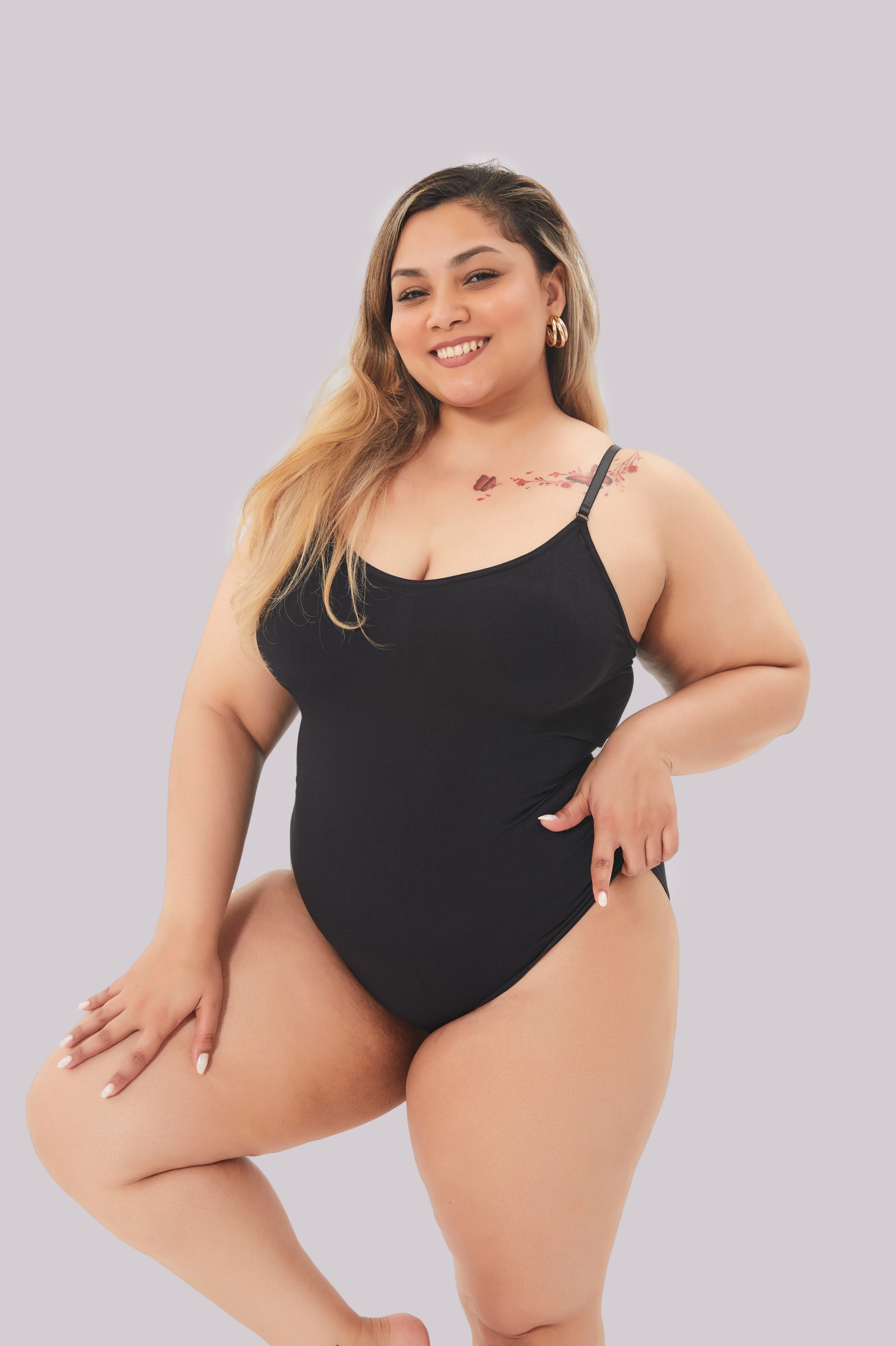 Black seamless shaping bodysuit worn by model, front view