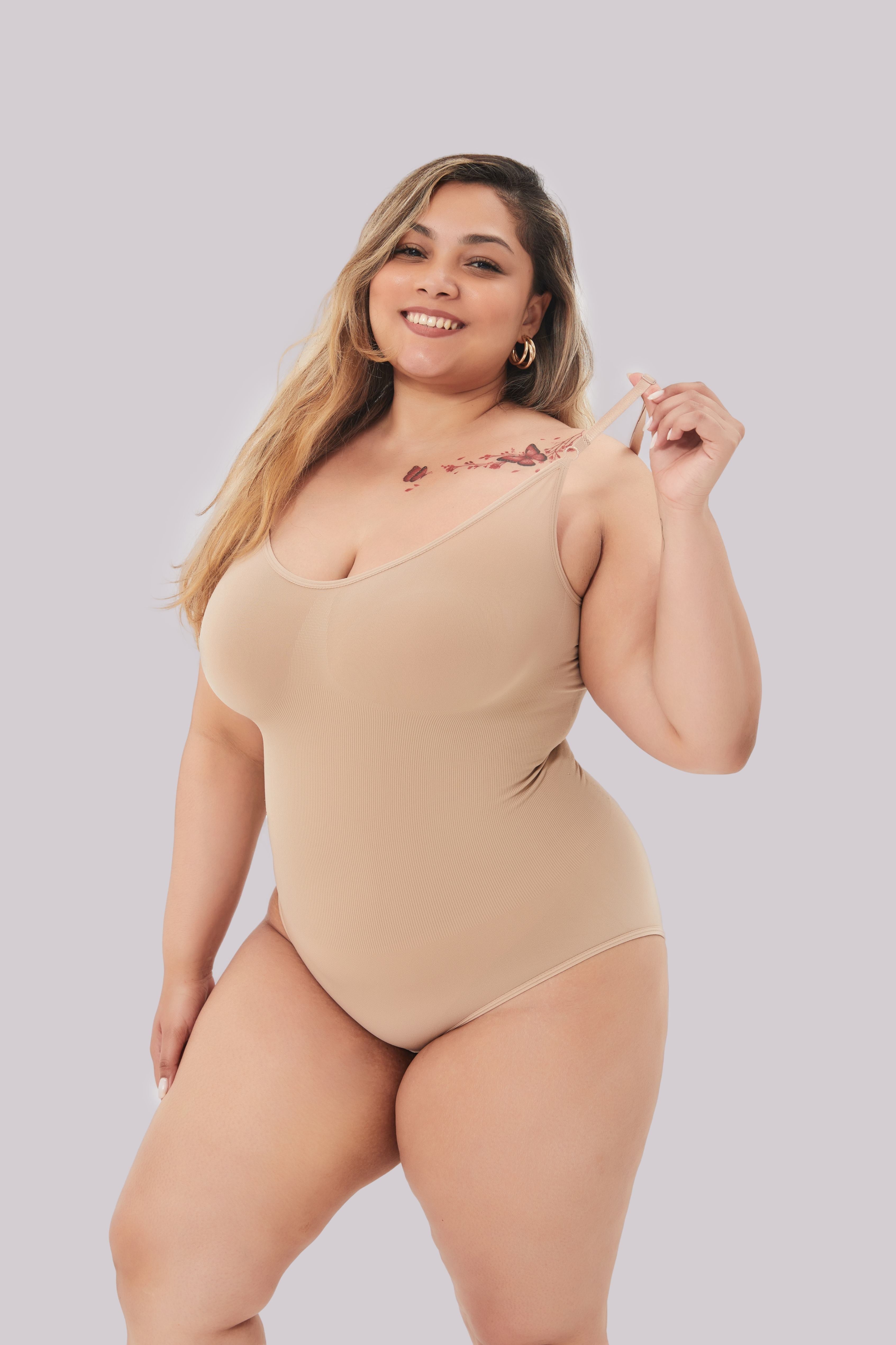 Beige seamless shaping bodysuit worn by model, front view
